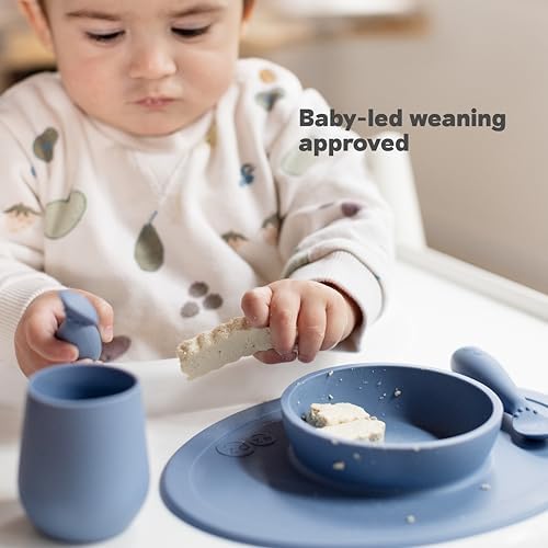 Compact Sage Ezpz baby led weaning mat packaged inside its reusable diaper bag pouch