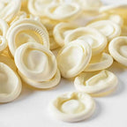 White disposable 4 Mil thick finger sleeves spread out on a clean workbench