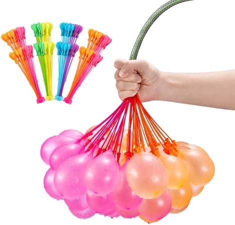 Bright multi colored tropical theme water balloons resting inside a water filled bucket prepared for outdoor play.