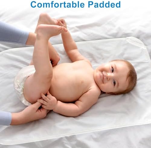 Lightweight baby changing mat being slipped into a compact travel diaper bag