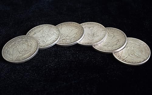 Detailed view of metal Morgan Dollar magic props with milled edges