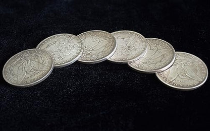 Detailed view of metal Morgan Dollar magic props with milled edges