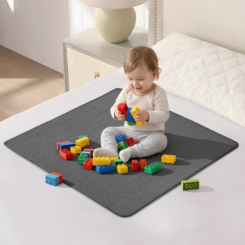 Inooro reusable waterproof bed pads spread flat on a mattress demonstrating the non slip backing placement.