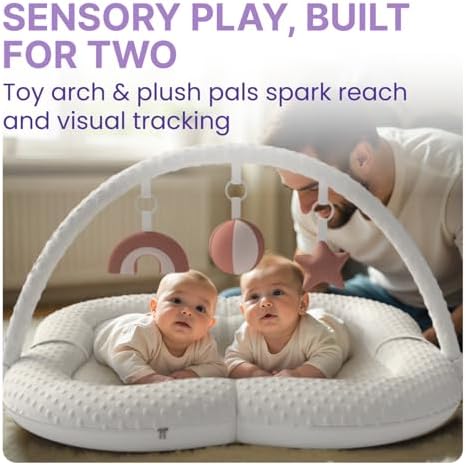 Baby engaging with developmental flashcards on play mat