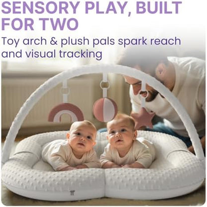 Baby engaging with developmental flashcards on play mat