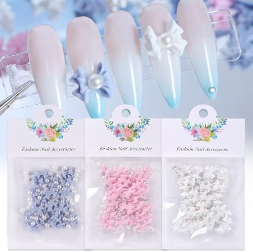 Close up of 3D resin flower nail charms in pink and white
