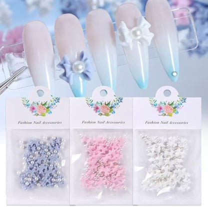 Close up of 3D resin flower nail charms in pink and white