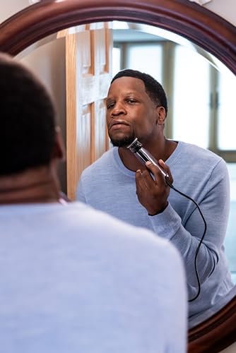 Andis black corded hair trimmer being prepped for skin close dry shaving and fading