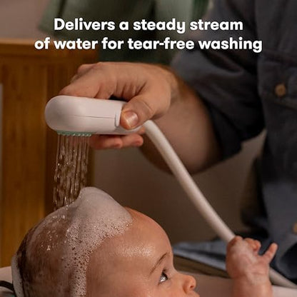 Frida Baby electric suction pump and long hose attachment secured to a baby bathtub floor for continuous water flow.