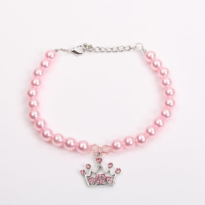 Side view of the pink pearl pet collar showcasing the shiny finish and crown design