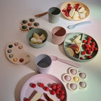 Authentic Mushie chemical-free silicone spoons in elegant Scandinavian pastel tones for baby meals.