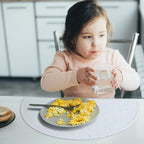 BPA free non slip baby table mat being wiped clean with a cloth