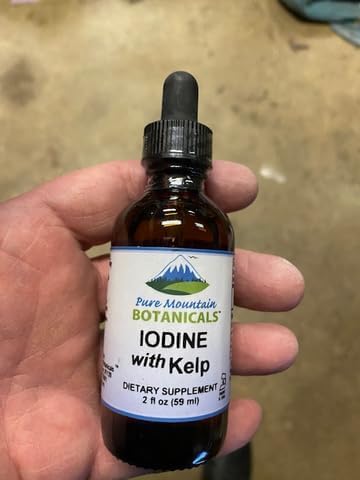 Close up of organic kelp thyroid drops supplement label detailing unflavored serving size.