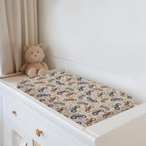 Baby nursery changing table styled with tractor print cover