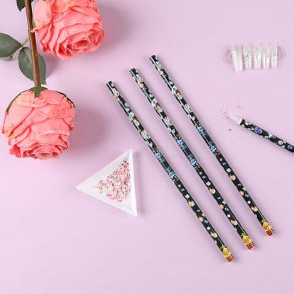 Blulu wax picker pencils being used to lift a single crystal rhinestone from a sorting plate