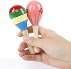 Close up view of the durable wood handle and non toxic paint details on the infant sand hammer toy