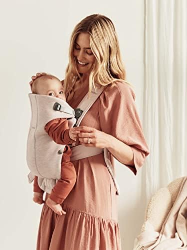 Parent wearing BabyBjorn Mini carrier for newborn