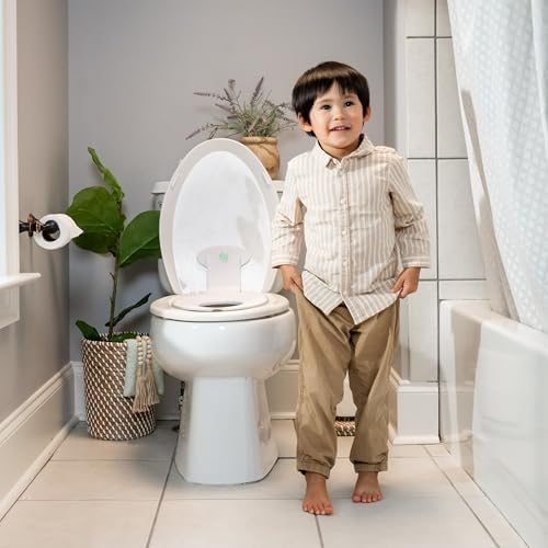 Ingenuity toddler toilet training ring flipped up against the lid for adult bathroom use