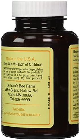 Close up shot of the family owned Durham's Bee Farm propolis capsules container for daily health routine.