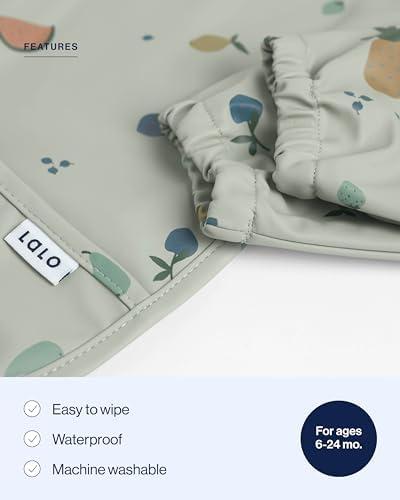 Detailed view of the large catch all pocket on the Lalo infant smock bib for catching food spills.