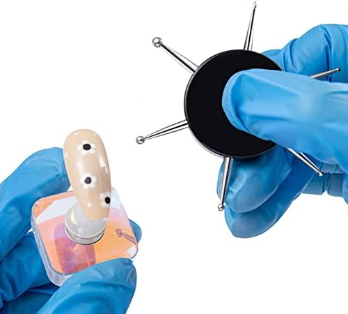 Close up of the six different stainless steel dotting heads on the black circular manicure pen.