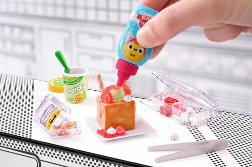 Assembled mini diner food replica being cured under a UV light source