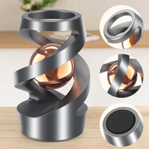 Close up of rose gold ball on kinetic desk toy