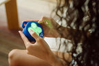 Back view of Buffalo Games sensory puzzle device showing the mechanical reset button.