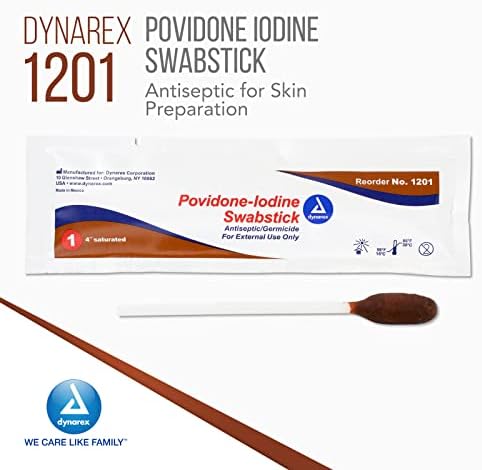 Brown povidone iodine antiseptic stick being removed from foil packaging
