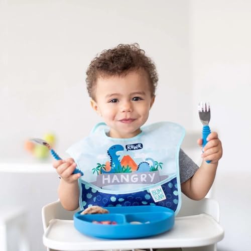 Bumkins dinosaur print waterproof bib spread flat demonstrating the stain resistant fabric texture