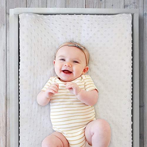 The Peanutshell classic white minky changing table cover stretched over a standard mattress pad