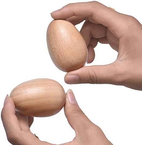 Four wooden hand percussion musical eggs arranged neatly on a neutral background