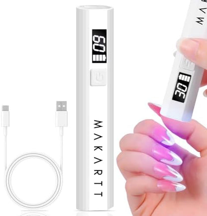 Portable mini cordless flash cure nail lamp being held to dry individual nail extension art.