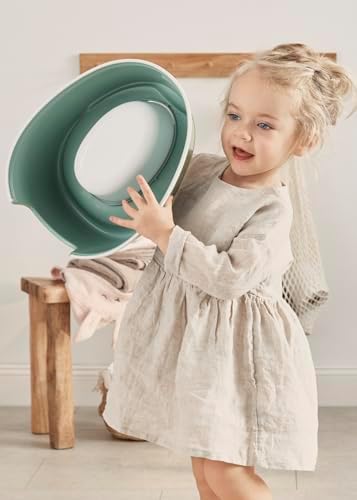 Toddler sitting on BabyBjörn Smart Potty Deep Green