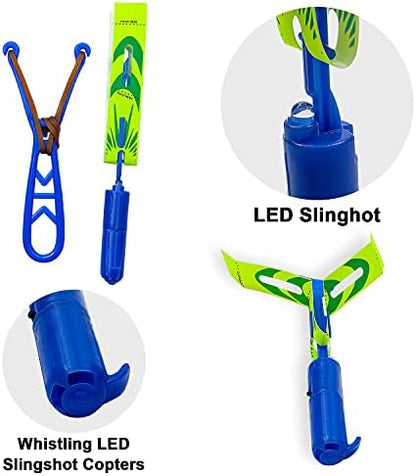 Child holding the elastic slingshot launcher aimed towards the open sky.