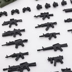 Assorted miniature tactical rifles and pistols from the HIMIRICH toy soldier set laid out neatly