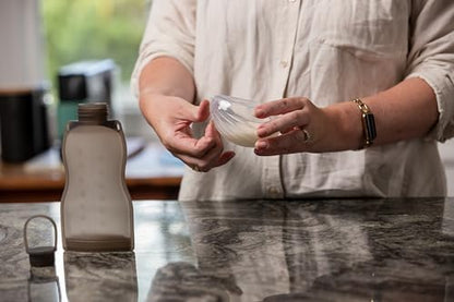 Discreet hands free breast milk collector by Haakaa fitting comfortably inside a nursing bra.