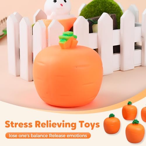 A hand squeezing the orange carrot toy to demonstrate the surprise pop-up mechanism