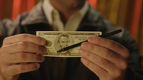 Magic Mystery Pen Trick close up view of the undamaged currency note after performance