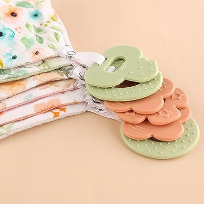 Baby wearing Vuminbox bandana bib with integrated teether accessory