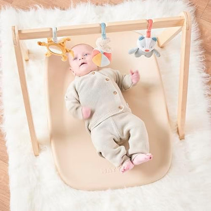 Beige Nattou Softy changing mat on wooden dresser