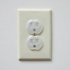 Dreambaby clear outlet plug guards inserted into power socket
