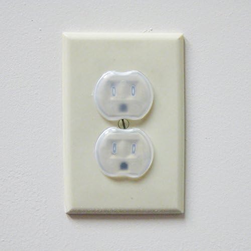 Dreambaby clear outlet plug guards inserted into power socket