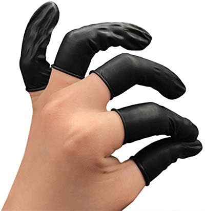 Black rubber industrial fingerstall sleeves laid out on a clean workbench