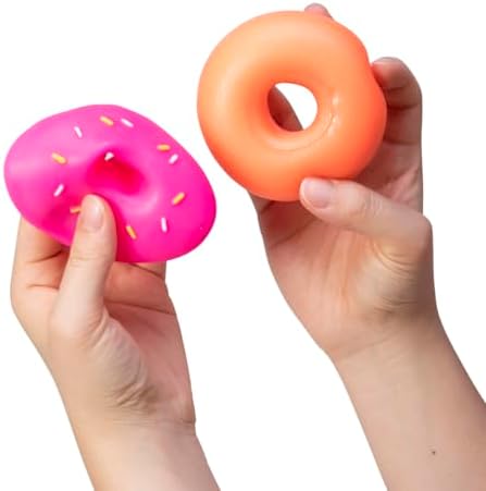 Top view of three different neon colored Schylling sensory donuts on a clean backdrop.