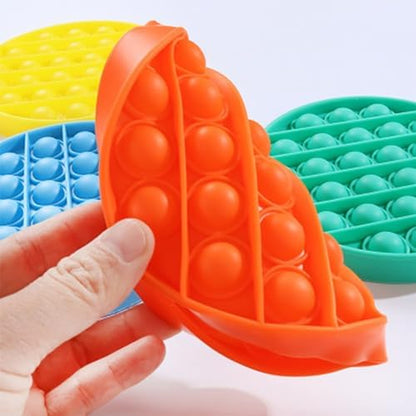 Portable washable silicone sensory tool being pressed by adult fingers for focus enhancement.