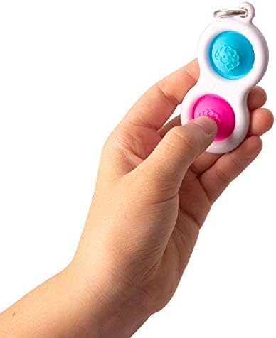 Fat Brain Toys Simpl Dimpl keychain attached to a school backpack