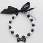 PetFavorites diamond dog necklace front view showing black pearls and rhinestone bone charm.