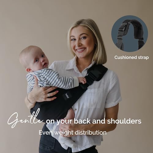 Ergonomic toddler hip carrier with adjustable straps and secure buckle closure on a parent.