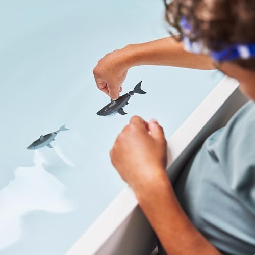 Kids playing with Zuru Robo Alive electronic water activated sharks in bathtub